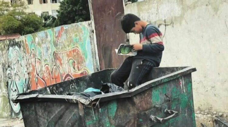 Xposure To Sponsor Refugee Boy Photographed Reading A Book in The Garbage